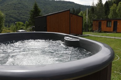 Photo of Tub with hot water at luxury resort in mountains, closeup