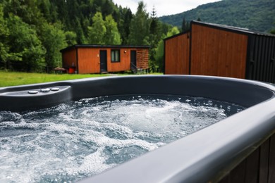 Photo of Tub with hot water at luxury resort in mountains, closeup