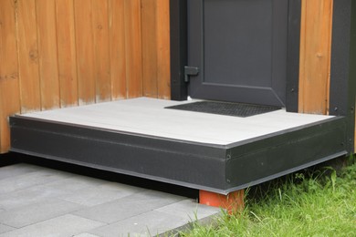 Photo of Doorstep and mat near hotel door at luxury resort, closeup
