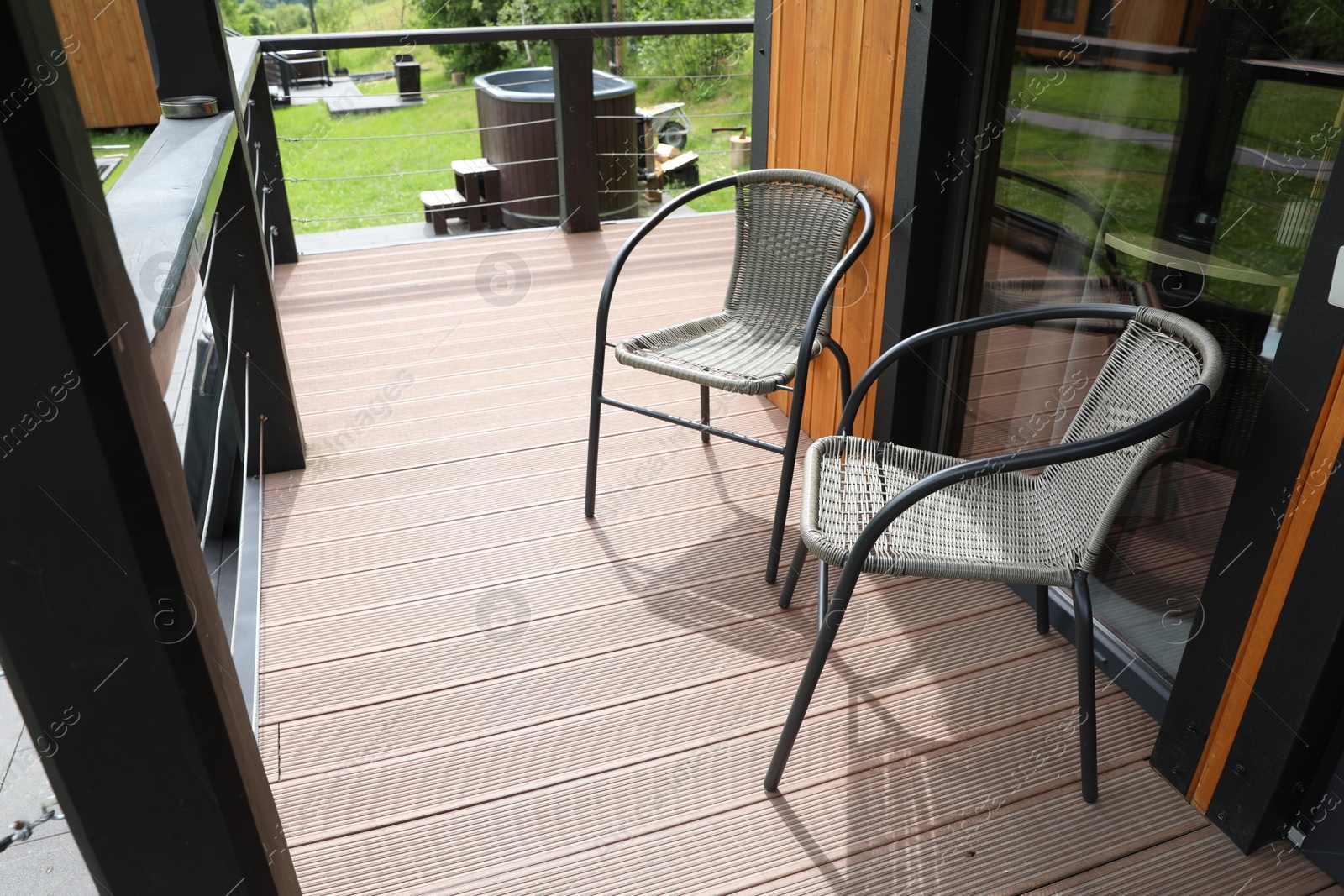 Photo of Rattan chairs on outdoor terrace at luxury resort in mountains