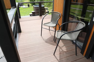 Photo of Rattan chairs on outdoor terrace at luxury resort in mountains