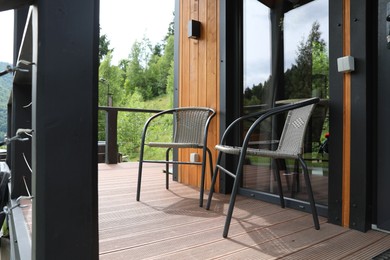 Photo of Rattan chairs on outdoor terrace at luxury resort in mountains