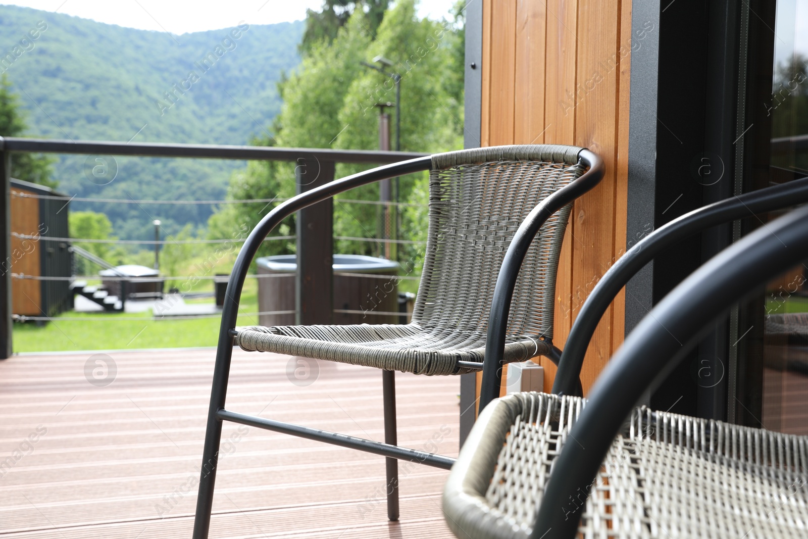 Photo of Rattan chairs on outdoor terrace at luxury resort in mountains