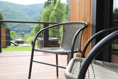 Photo of Rattan chairs on outdoor terrace at luxury resort in mountains