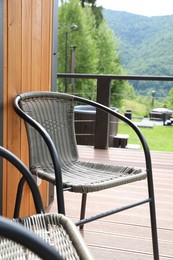 Photo of Rattan chairs on outdoor terrace at luxury resort in mountains
