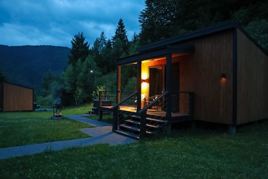 Photo of Picturesque view of luxury hotel in mountains at night