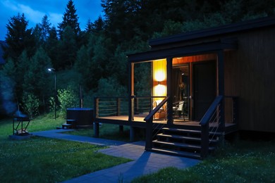 Photo of Picturesque view of luxury hotel in mountains at night