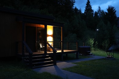 Photo of Picturesque view of luxury hotel in mountains at night