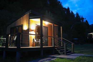 Photo of Picturesque view of luxury hotel in mountains at night