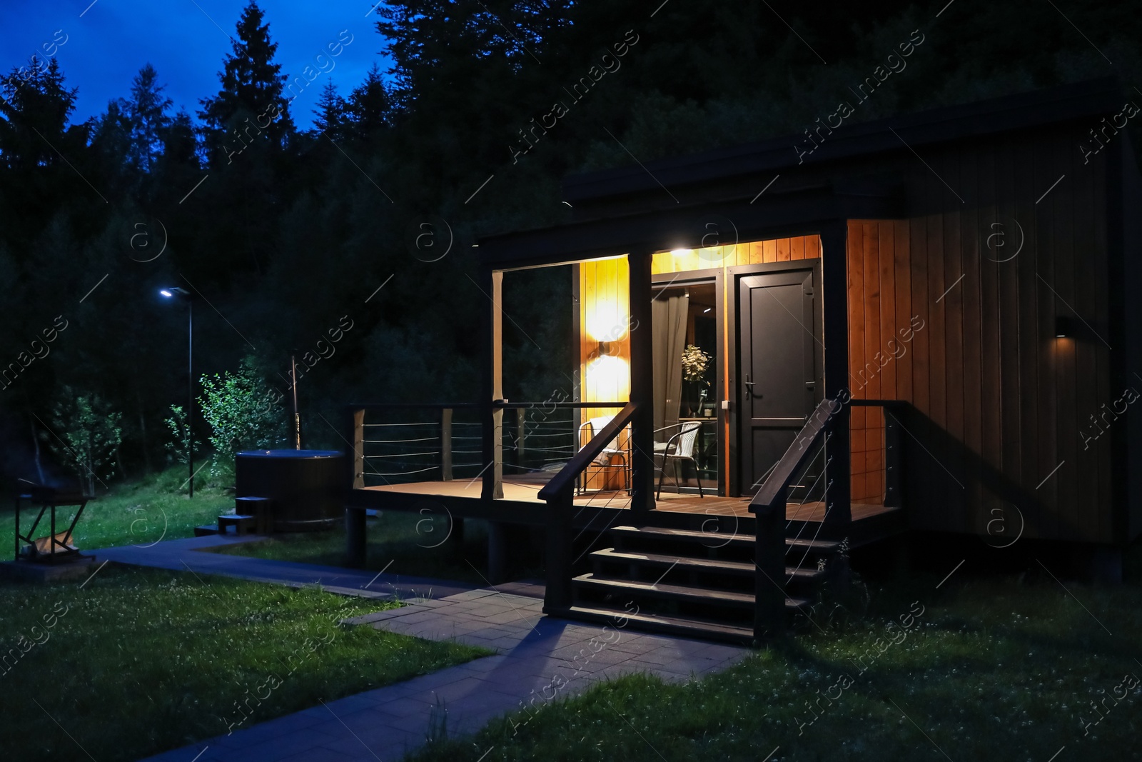 Photo of Picturesque view of luxury hotel in mountains at night