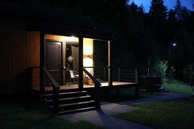 Photo of Picturesque view of luxury hotel in mountains at night