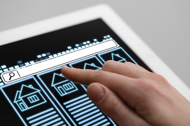 Image of Searching for housing online. Real estate agent using tablet computer, closeup. Search bar and house data on device screen