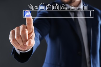 Image of Real estate agent using virtual screen with search bar and houses against dark grey background, closeup. Searching for housing online
