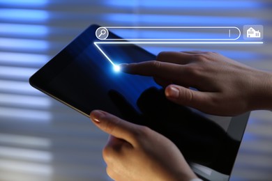 Image of Searching for housing online. Real estate agent using tablet computer indoors, closeup. Search bar with house icon above device