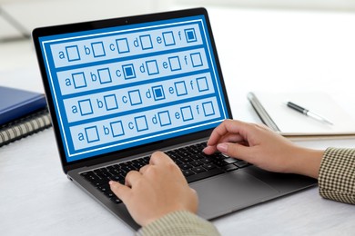 Image of Woman passing online test on laptop at table, closeup