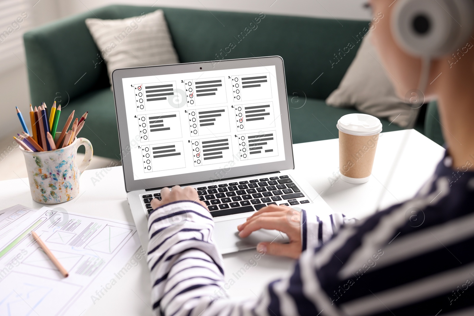 Image of Woman passing online test on laptop at table, closeup