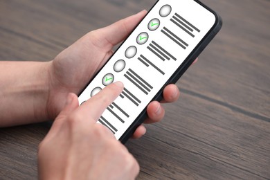 Image of Woman passing online test on her mobile phone at home, closeup