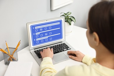 Image of Woman passing online test on laptop at table, closeup