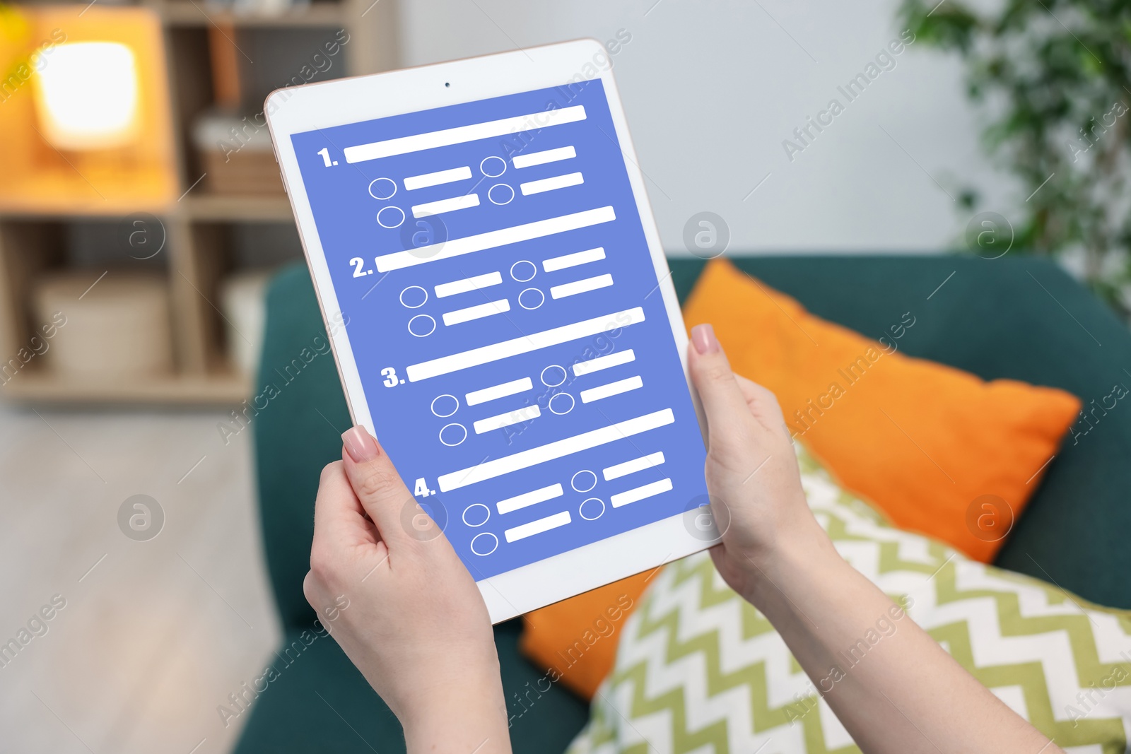 Woman passing online test on tablet computer at home, closeup Image of Woman passing online test on tablet computer at home, closeup
