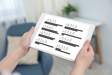 Image of Woman passing online test on tablet computer at home, closeup