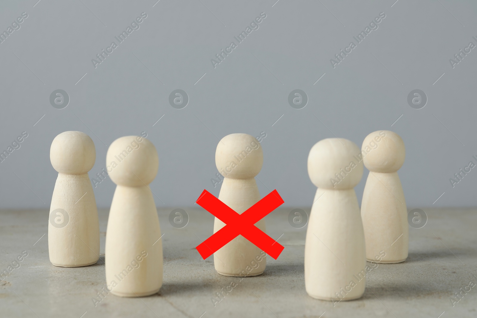 Dismissal. One human figure with red cross among others on grey table Image of Dismissal. One human figure with red cross among others on grey table