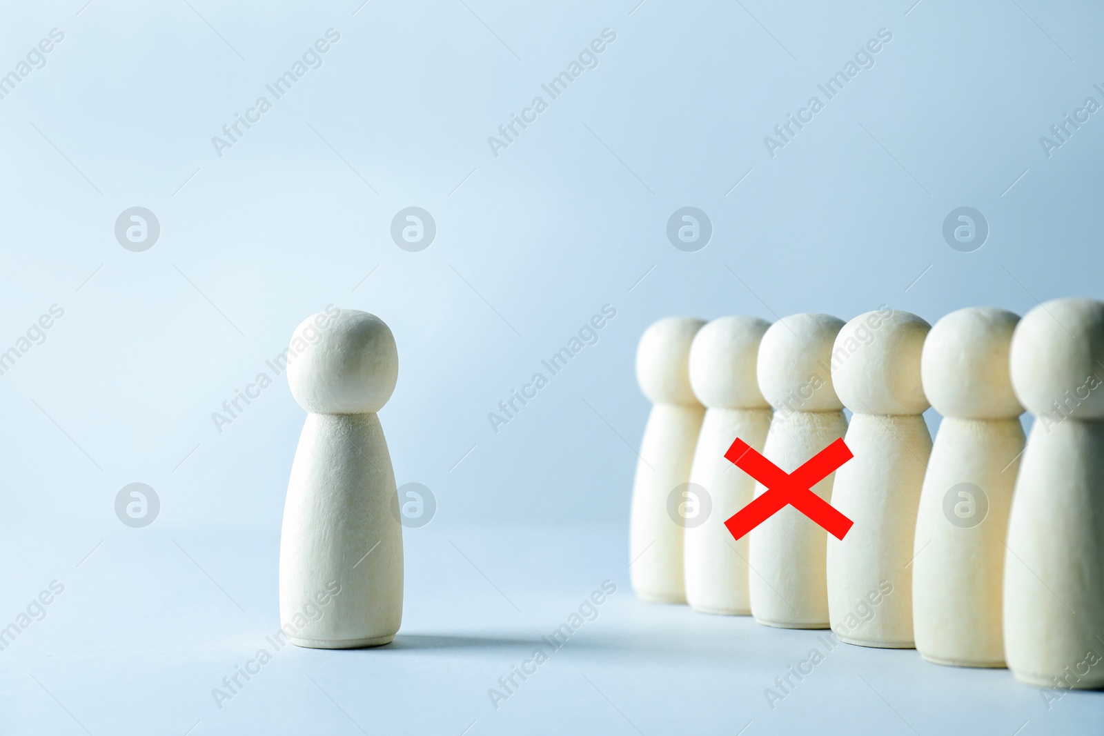 Dismissal. One human figure with red cross among others on grey table Image of Dismissal. One human figure with red cross among others on grey table