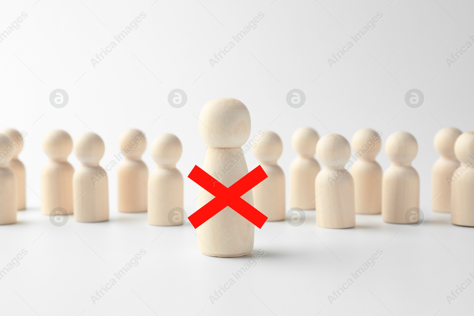 Dismissal. One human figure with red cross among others on white table Image of Dismissal. One human figure with red cross among others on white table