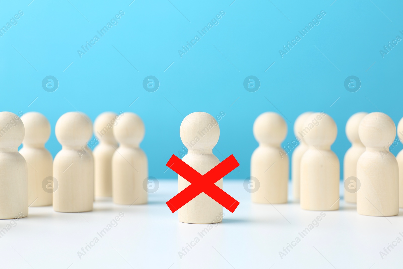 Dismissal. One human figure with red cross among others on white table Image of Dismissal. One human figure with red cross among others on white table