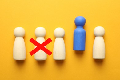 Image of Dismissal. One human figure with red cross among others on orange background, top view