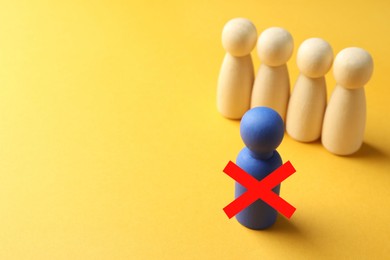 Image of Dismissal. One blue human figure with red cross among others on orange background