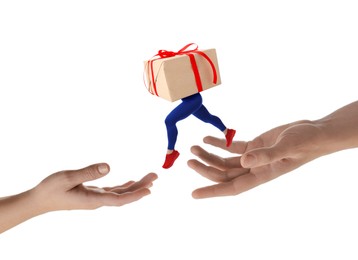 Image of Gift box with woman's legs jumping from one hand to another on white background