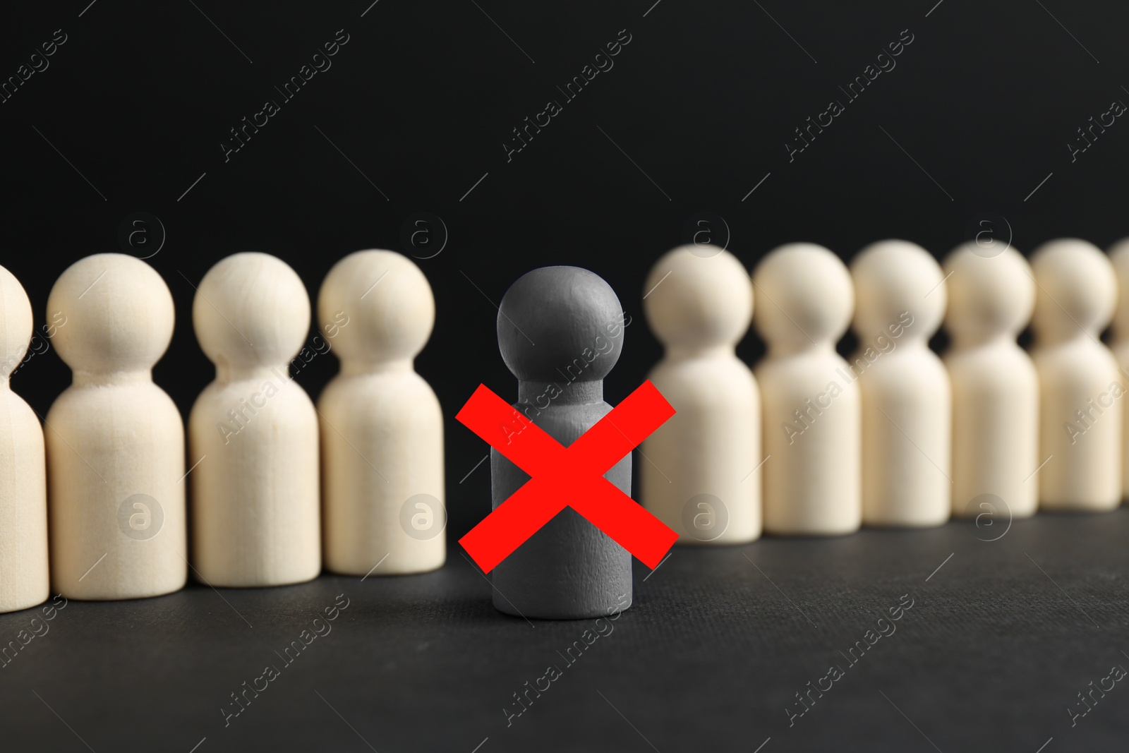 Dismissal. One grey human figure with red cross among others on black table Image of Dismissal. One grey human figure with red cross among others on black table