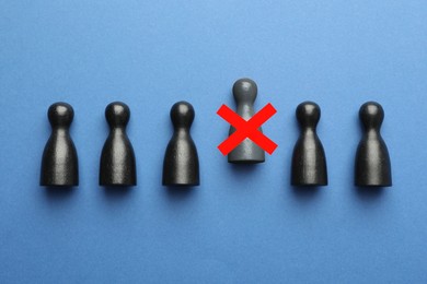 Image of Dismissal. One grey human figure with red cross among others on blue background, top view