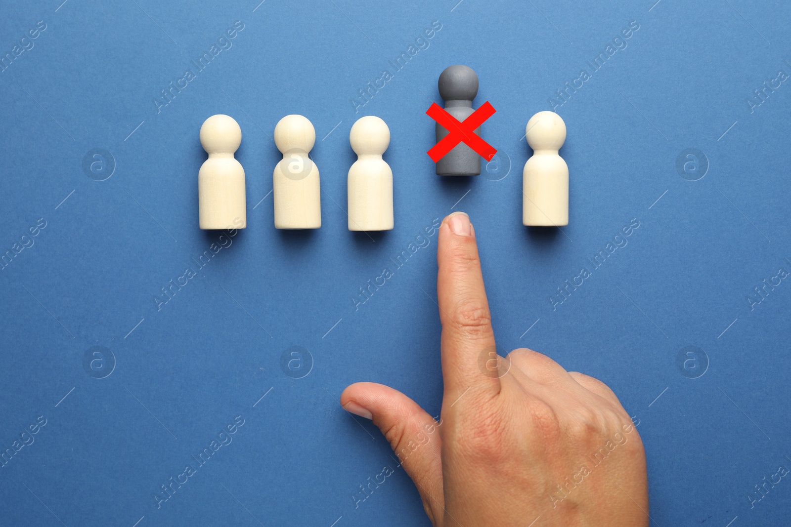 Dismissal. Woman throwing human figure with red cross away on blue background, top view Image of Dismissal. Woman throwing human figure with red cross away on blue background, top view