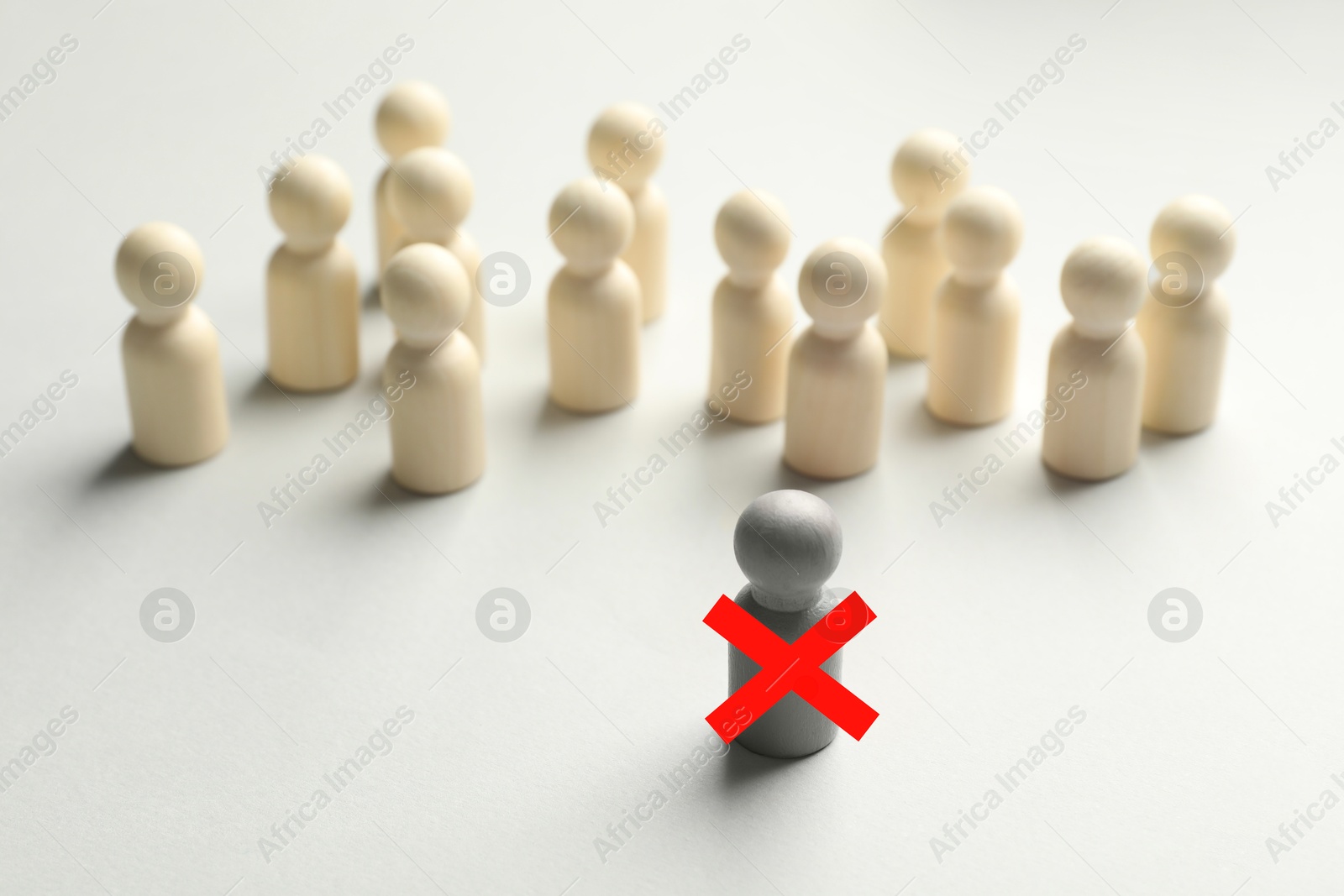Dismissal. One grey human figure with red cross among others on white table Image of Dismissal. One grey human figure with red cross among others on white table