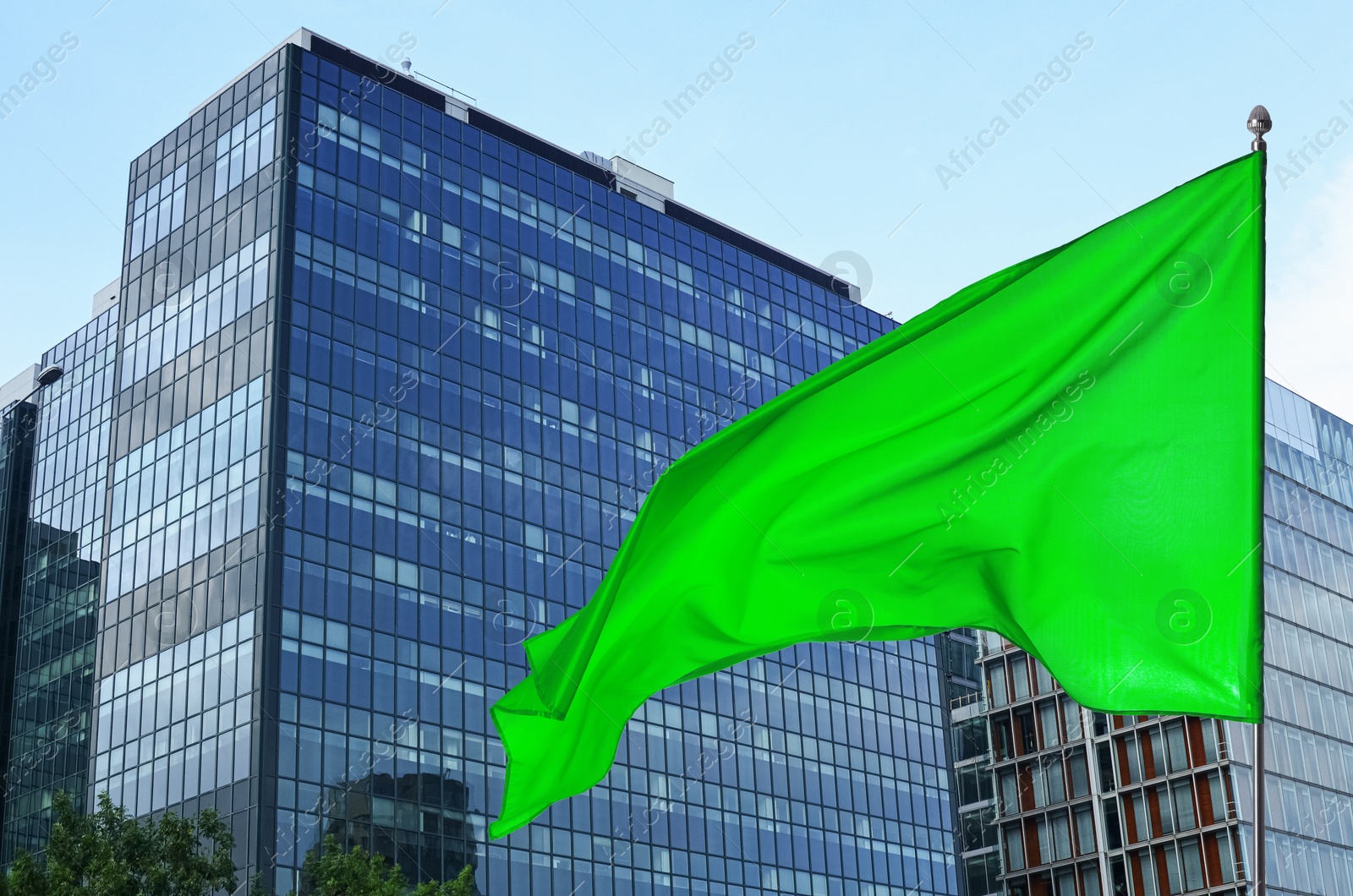 Bright green flag waving against building outdoors Image of Bright green flag waving against building outdoors