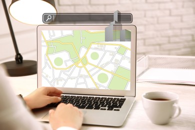 Image of Searching for housing online. Real estate agent using laptop at table, closeup. Search bar with buildings above computer