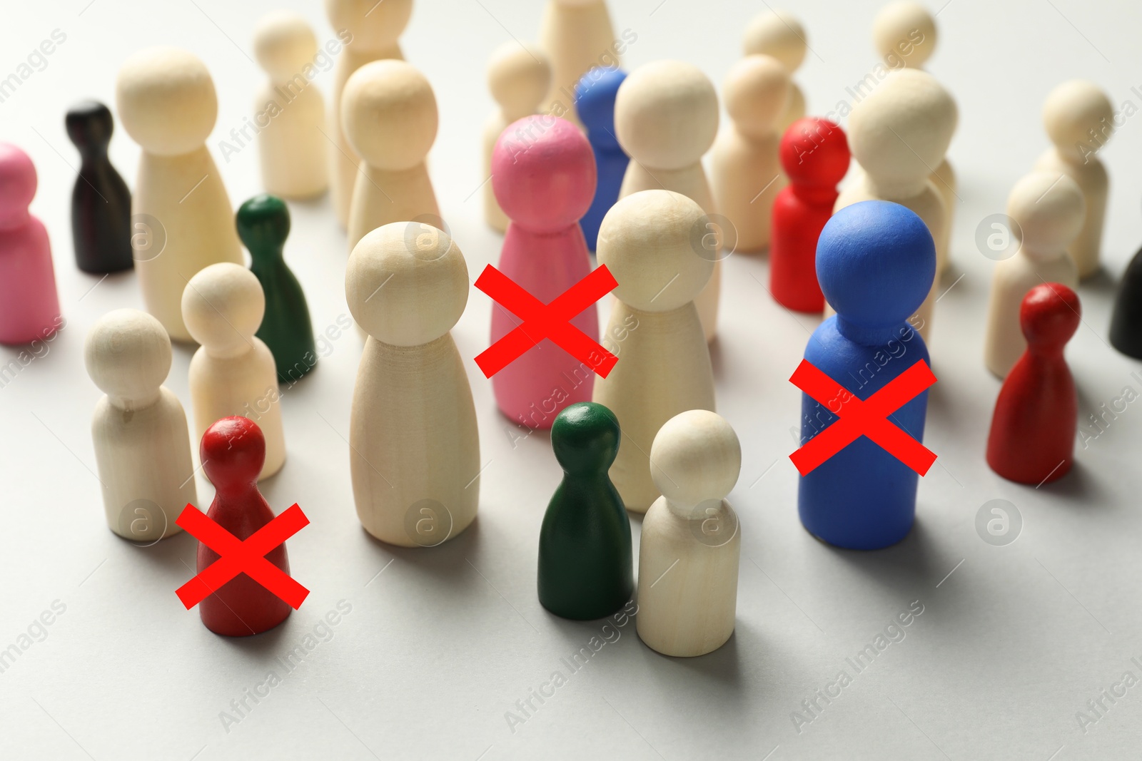 Dismissal. Three human figures with red crosses among others on white table Image of Dismissal. Three human figures with red crosses among others on white table
