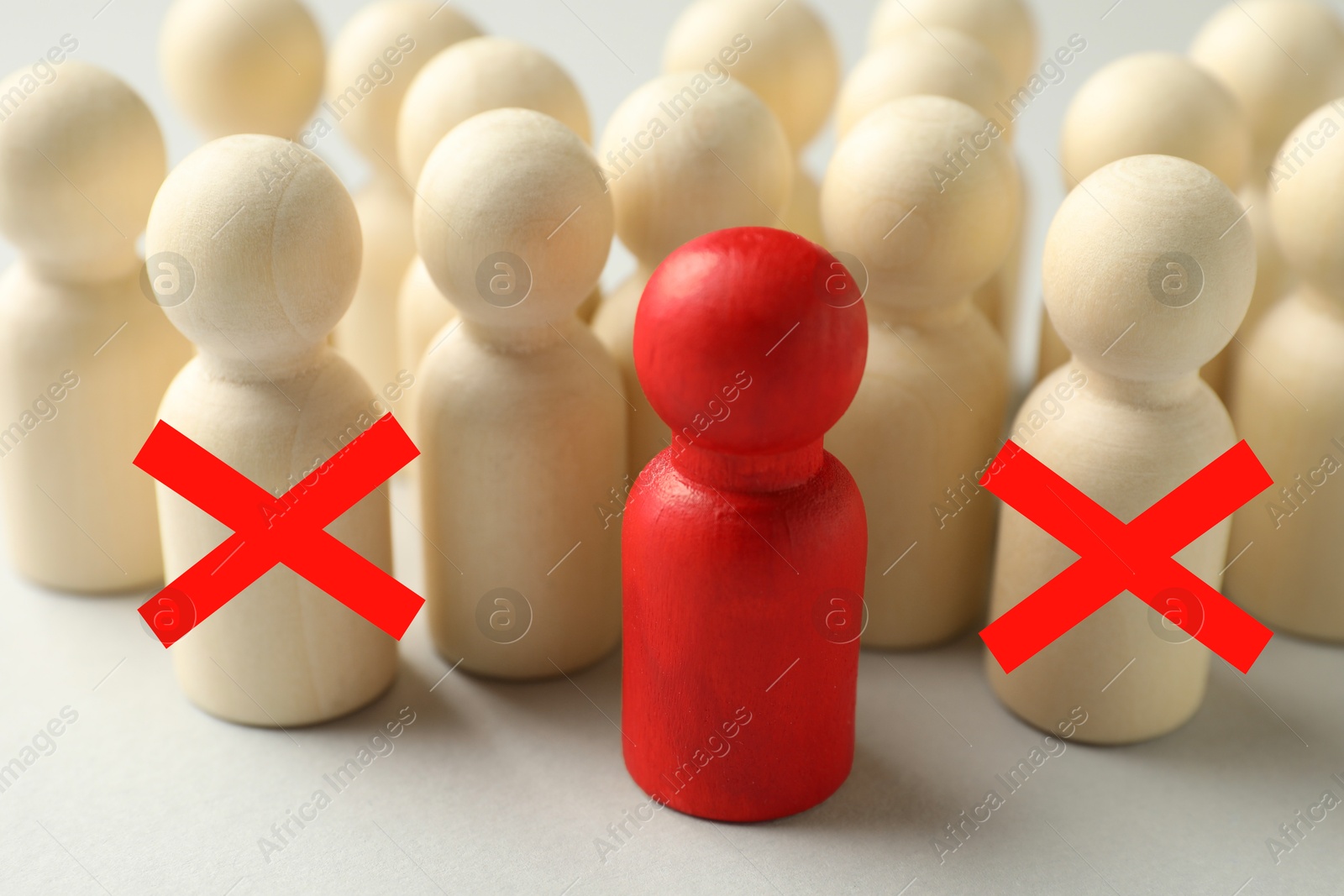 Dismissal. Two human figures with red crosses among others on white table. Red figure - boss or HR manager Image of Dismissal. Two human figures with red crosses among others on white table. Red figure - boss or HR manager