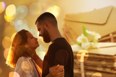 Image of Romantic young couple and love letters, bokeh effect