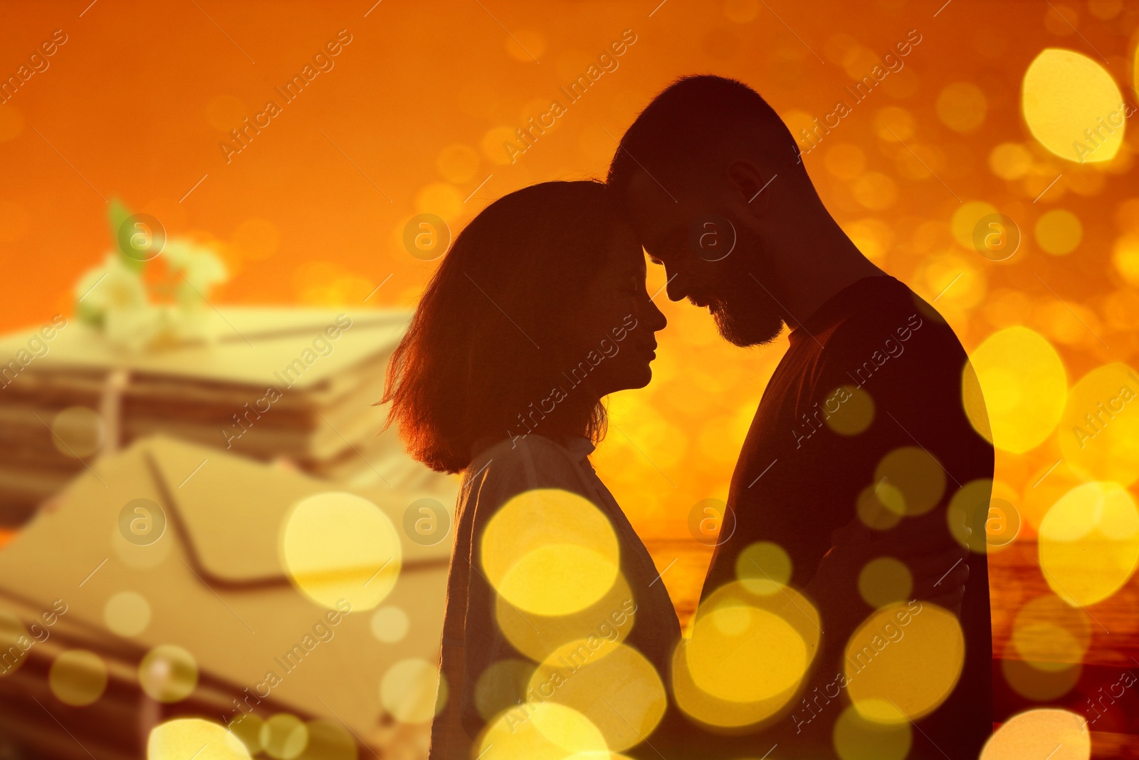 Romantic young couple and love letters against orange background, bokeh effect Image of Romantic young couple and love letters against orange background, bokeh effect
