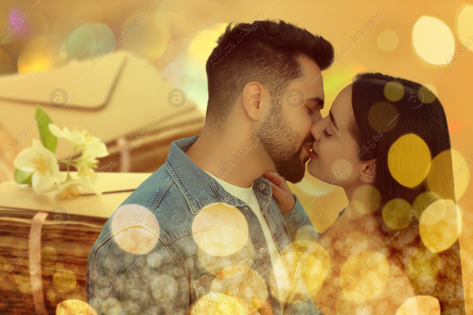 Romantic young couple and love letters, bokeh effect. Woman and man kissing Image of Romantic young couple and love letters, bokeh effect. Woman and man kissing