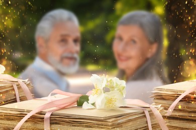 Image of Romantic senior couple outdoors and love letters, bokeh effect