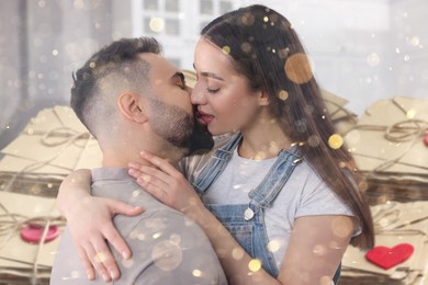 Image of Romantic young couple and love letters, bokeh effect. Woman and man kissing at home