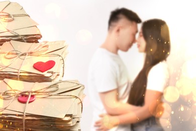 Image of Romantic couple and love letters, bokeh effect. Woman and man hugging on light background