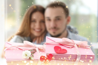 Image of Romantic young couple at home and love letters, bokeh effect