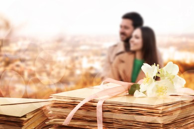 Image of Romantic couple outdoors and love letters, bokeh effect