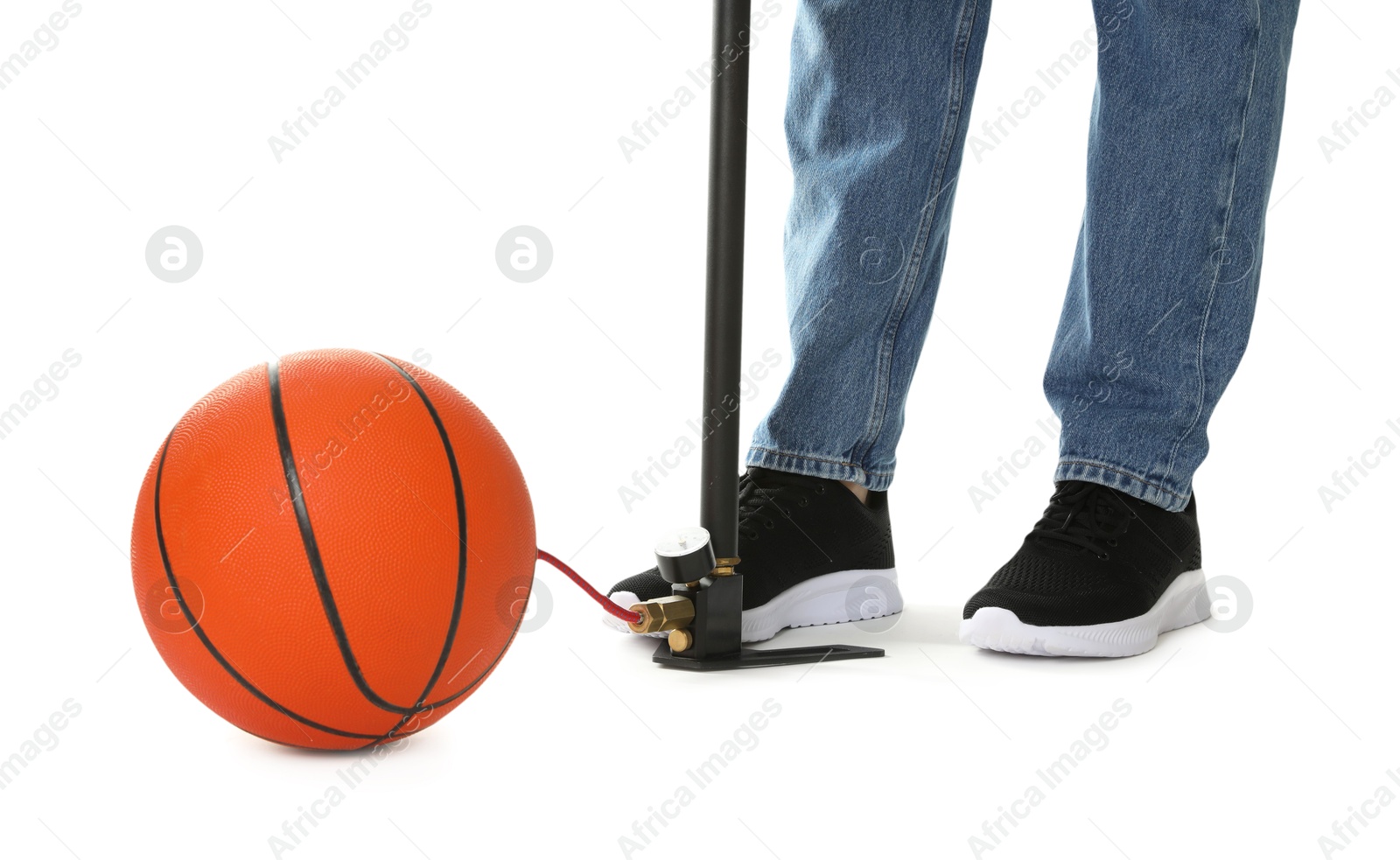 Photo of Man inflating basketball ball with manual air pump on white background, closeup