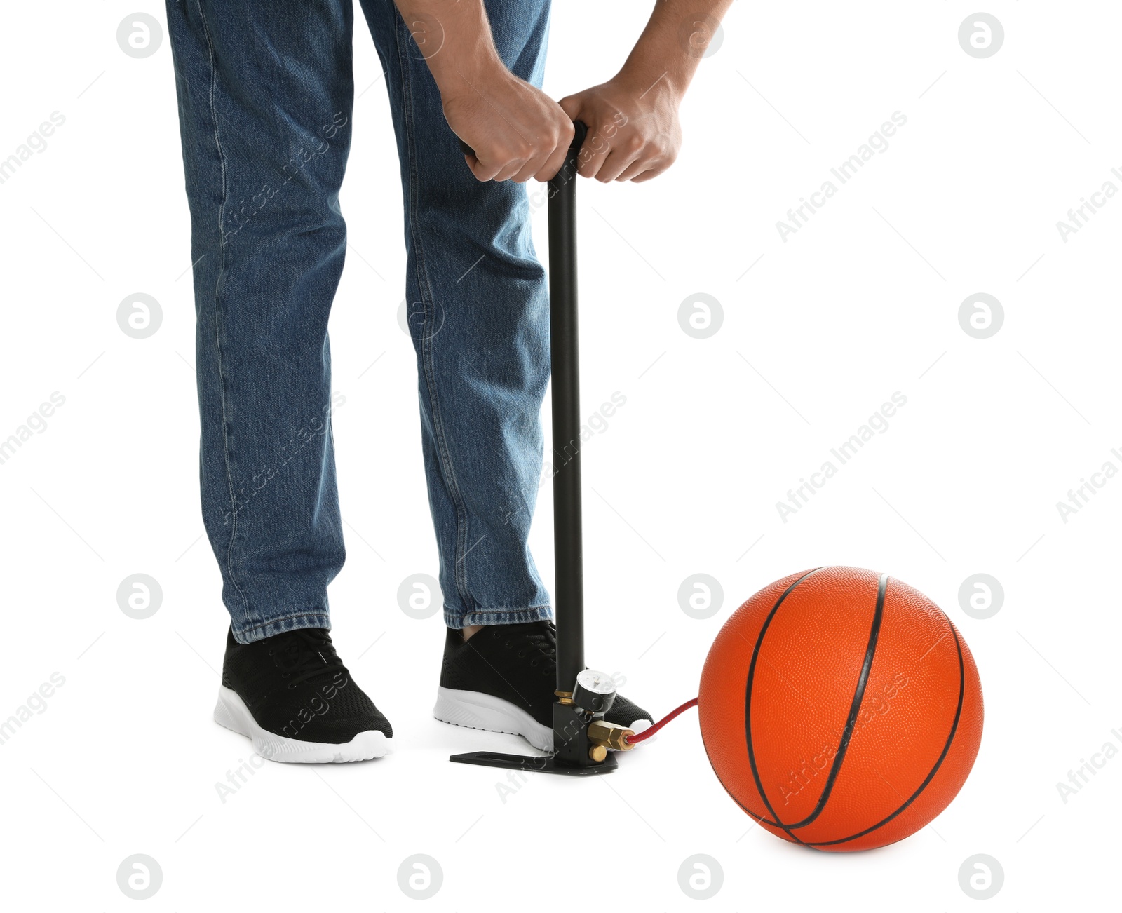 Photo of Man inflating basketball ball with manual air pump on white background, closeup