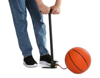 Photo of Man inflating basketball ball with manual air pump on white background, closeup